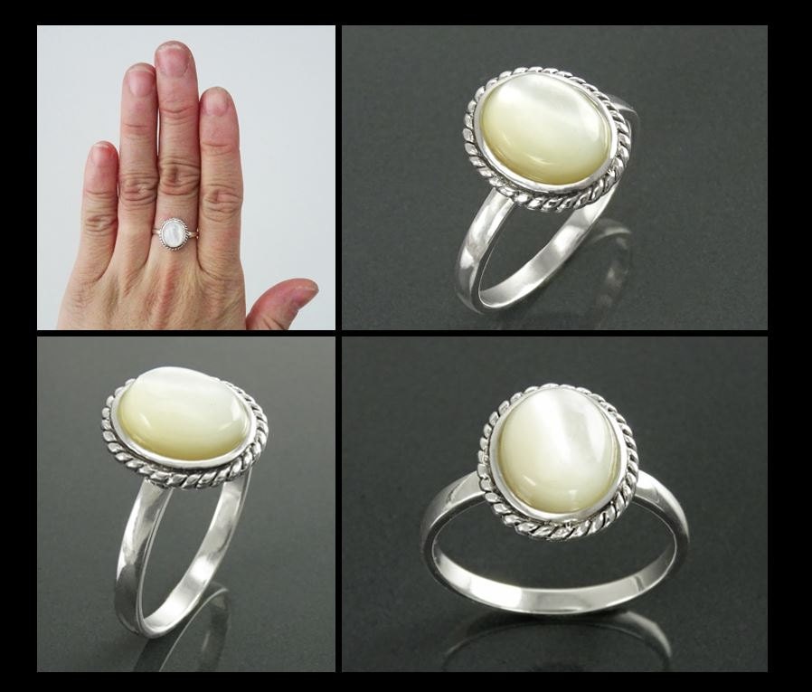 Une bague en argent avec une pierre ovale blanche sertie dans une bordure en forme de corde portée sur une main. Un bijou artisanal durable, fait main local par des créateurs de confiance recommandée pas ses clients (milliers d'avis positifs).