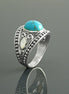 Une bague bohème en argent avec une pierre turquoise et une incrustation de nacre blanche. La bague est ornée d'un motif vintage perlé