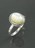 Une bague en argent 925 avec une pierre ovale blanche sertie dans une bordure en forme de corde. Un bijou artisanal durable. Fait à la main localement. Boutique de confiance recommandée par ses clients.