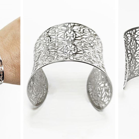A silver-colored cuff bracelet with an openwork floral design. The wide bracelet is shown on a wrist and in two other views. The metal jewelry has a curved shape and intricate cut-out patterns.
Brand: KRAMIKE
Type of jewelry: cuff / statement armor cuff
Metal: stainless steel
Color: silver-tone
Style: Filigree floral lace / modern boho
Diameter: 66 mm
Width: 60 mm
Ships from: France