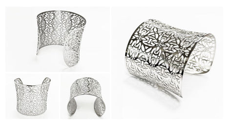 Multiple views — A silver-colored cuff bracelet with an openwork floral design. The wide bracelet curves to fit the wrist and features a repeating pattern of stylized flowers and leaves. The metal has a polished finish.

Brand: KRAMIKE
Type of jewelry: cuff / statement armor cuff
Metal: stainless steel
Color: silver-tone
Style: Filigree floral lace / modern boho • cuff
Diameter: 66 mm
Width: 60 mm
Ships from: France