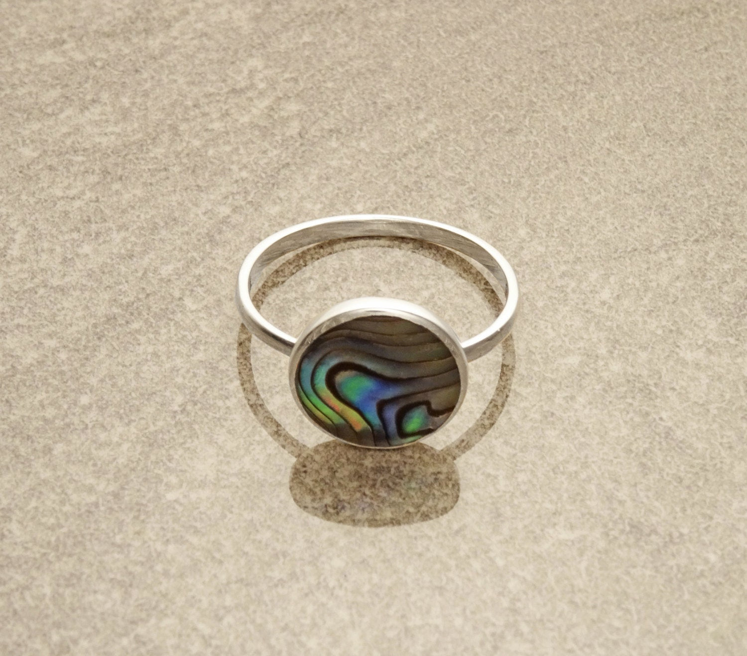 Round abalone ring, sterling silver set with genuine paua shell in a modern geometric stone design