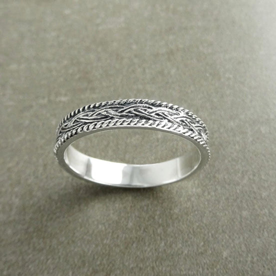 Une bague en argent massif 925 avec un motif tressé. 
La bague présente un motif détaillé de brins entrelacés, créant une surface texturée. Plusieurs vues mettent en valeur le savoir-faire et le design complexe de la bague.
Vu d'en bas.
Bijou artisanal durable. Fait main local. Boutique de confiance recommandée.