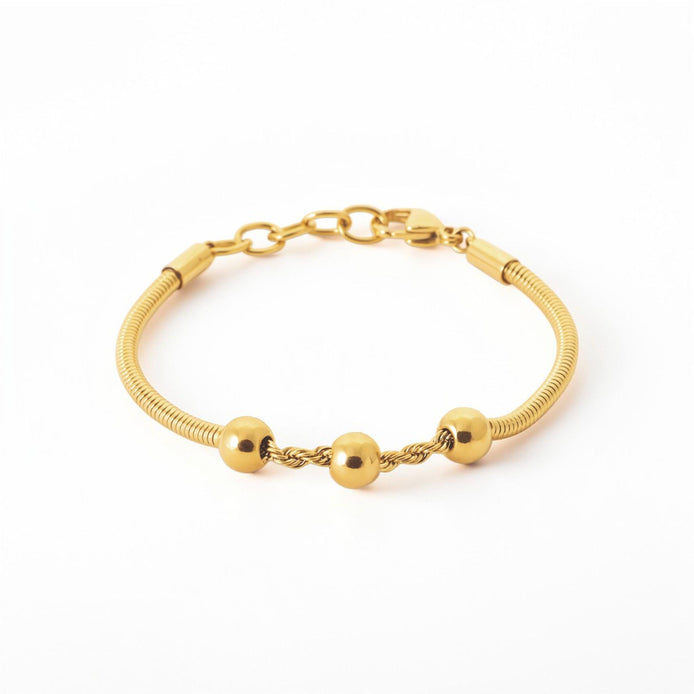 A Minimalist 18K Gold Filled Snake Chain with Triple Bead, lay on neutral background.
Product type: bracelet
Material: 18K gold filled, stainless steel
Length : adjustable 18-20cm
Width : 3mm
Clasp : lobster clasp
Color: yellow gold
Style: minimalist, dainty, elegant
Design details: snake chain, three polished beads, twisted connector detail
Best for: everyday wear, layering, gifting, minimalist jewelry lovers