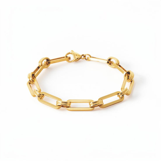 A 18K Gold Filled Paperclip Bracelet lay on a white studio background.
Product type: bracelet
Material:  18K Gold Filled, stainless steel base
Color: yellow gold
Style: minimalist, modern, elegant
Design details: elongated rectangular paperclip links, polished finish, geometric chain design, lobster clasp
Best for: everyday wear, layering, gifting, minimalist jewelry lovers, modern capsule wardrobes