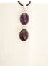 Peut inclure: Un collier en argent avec deux pierres d'améthyste de forme ovale. Les pierres sont d'une couleur violet foncé et sont serties d'argent.