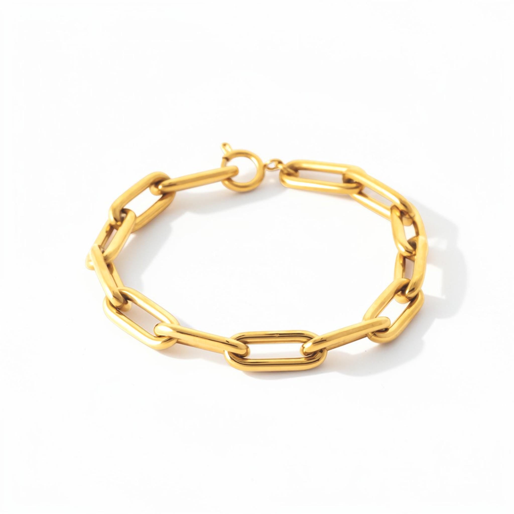 View of the bracelet in a studio white background.
Product type: bracelet
Material: 18K Gold Filled, stainless steel base
Color: yellow gold
Style: modern, elegant, minimalist, slightly bold
Design details: rectangular link chain, paperclip-style link, polished finish, lobster clasp
Best for: everyday wear, layering, gifting, modern jewelry lovers, statement minimal styling