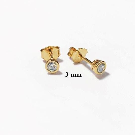 Product type: stud earrings
Material: gold
Stone: diamond 3mm 
Color: gold and clear white
Style: minimalist, classic, elegant, fine jewelry
Design details: round bezel-set diamonds, polished gold setting, stud earring silhouette, available in multiple sizes, timeless everyday design
Best for: everyday wear, second piercings, stacking, bridal jewelry, anniversary gifts, birthday gifts, fine jewelry lovers
