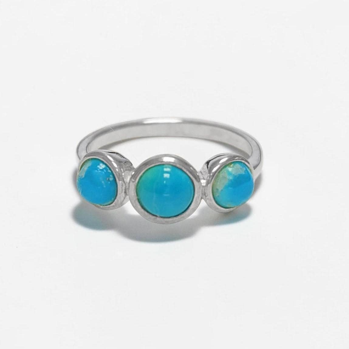 Product type: ring
Material: 925 sterling silver
Stone: turquoise
Color: silver with blue turquoise
Style: elegant, delicate, minimalist, feminine
Design details: slim sterling silver band, three round turquoise stones, polished setting, fine stackable profile, clean balanced design
Best for: everyday wear, stacking, gift giving, women who love turquoise jewelry, delicate gemstone rings, minimalist silver jewelry