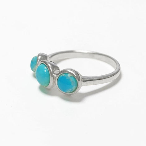 Product type: ring
Material: 925 sterling silver
Stone: turquoise
Color: silver with blue turquoise
Style: elegant, delicate, minimalist, feminine
Design details: slim sterling silver band, three round turquoise stones, polished setting, fine stackable profile, clean balanced design
Best for: everyday wear, stacking, gift giving, women who love turquoise jewelry, delicate gemstone rings, minimalist silver jewelry