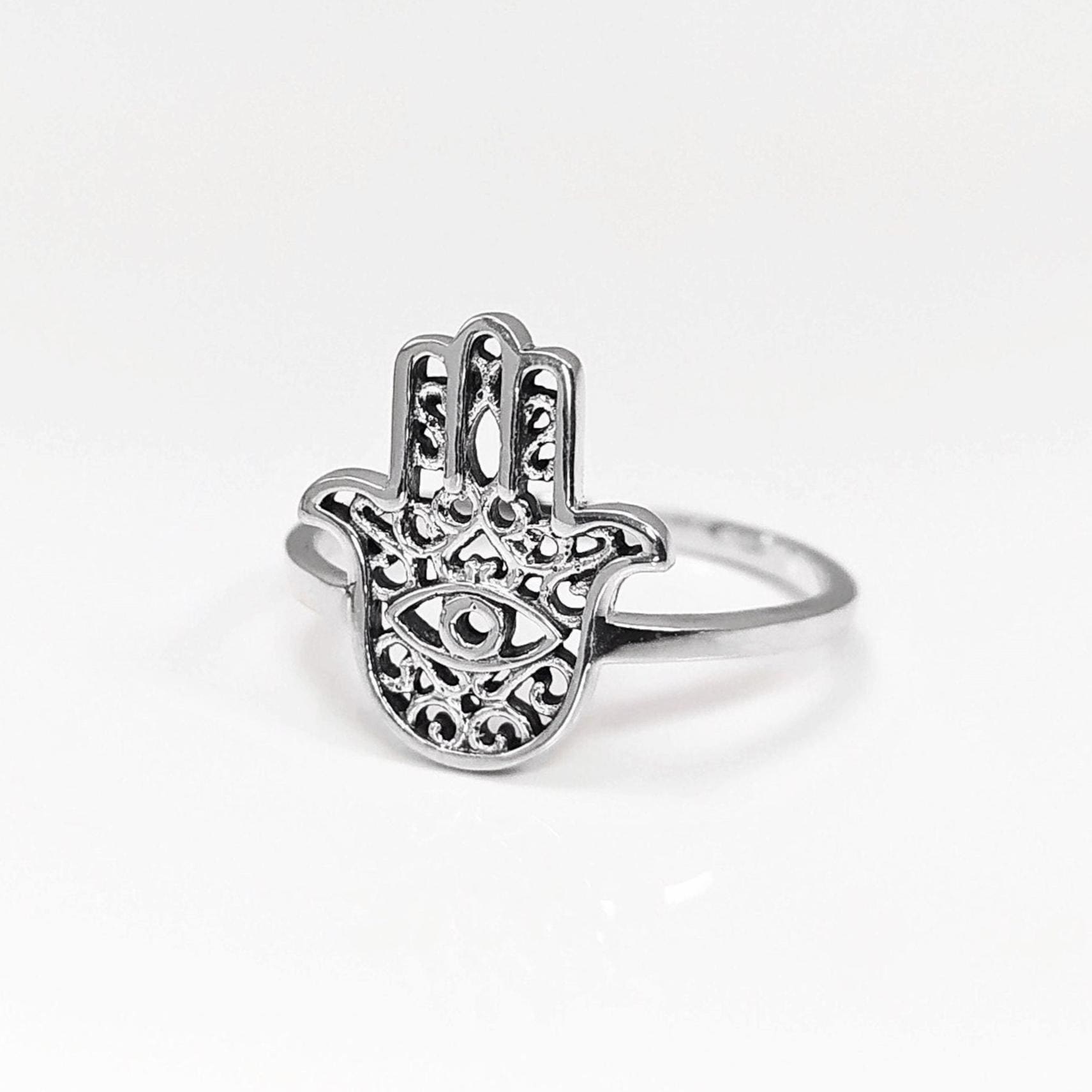Product type: ring
Material: sterling silver
Color: silver
Style: spiritual, symbolic, boho, delicate
Design details: Hamsa hand motif, centered evil eye symbol, openwork detailing, slim sterling silver band, minimalist everyday silhouette
Best for: everyday wear, symbolic jewelry lovers, spiritual gifting, protection-themed jewelry, stacking, birthdays, anniversaries, Mother’s Day