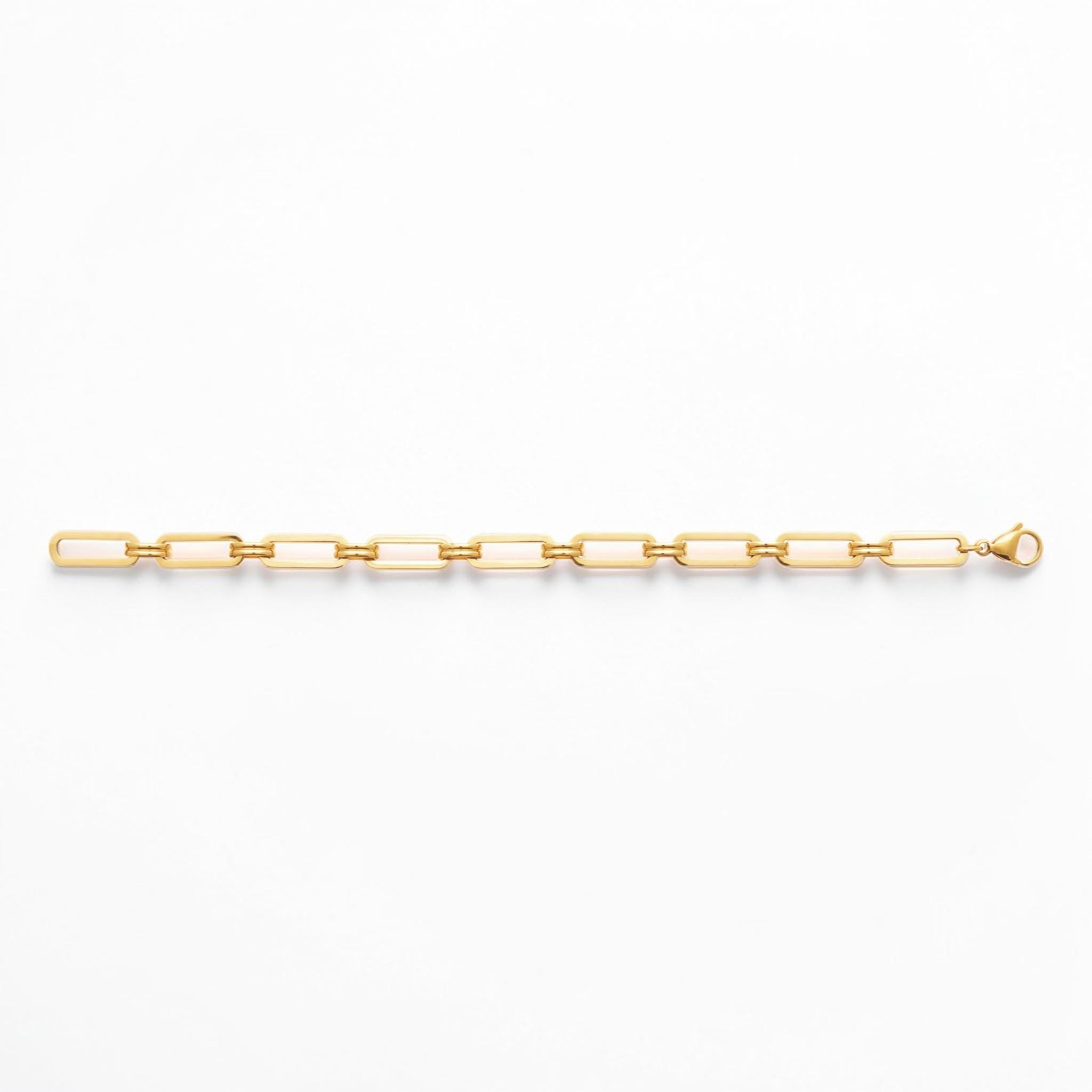 A 18K Gold Filled Paperclip Bracelet lay opened on a white studio background.
Product type: bracelet
Material:  18K Gold Filled, stainless steel base
Color: yellow gold
Style: minimalist, modern, elegant
Design details: elongated rectangular paperclip links, polished finish, geometric chain design, lobster clasp
Best for: everyday wear, layering, gifting, minimalist jewelry lovers, modern capsule wardrobes