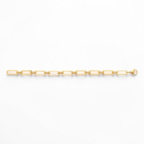 A 18K Gold Filled Paperclip Bracelet lay opened on a white studio background.
Product type: bracelet
Material:  18K Gold Filled, stainless steel base
Color: yellow gold
Style: minimalist, modern, elegant
Design details: elongated rectangular paperclip links, polished finish, geometric chain design, lobster clasp
Best for: everyday wear, layering, gifting, minimalist jewelry lovers, modern capsule wardrobes