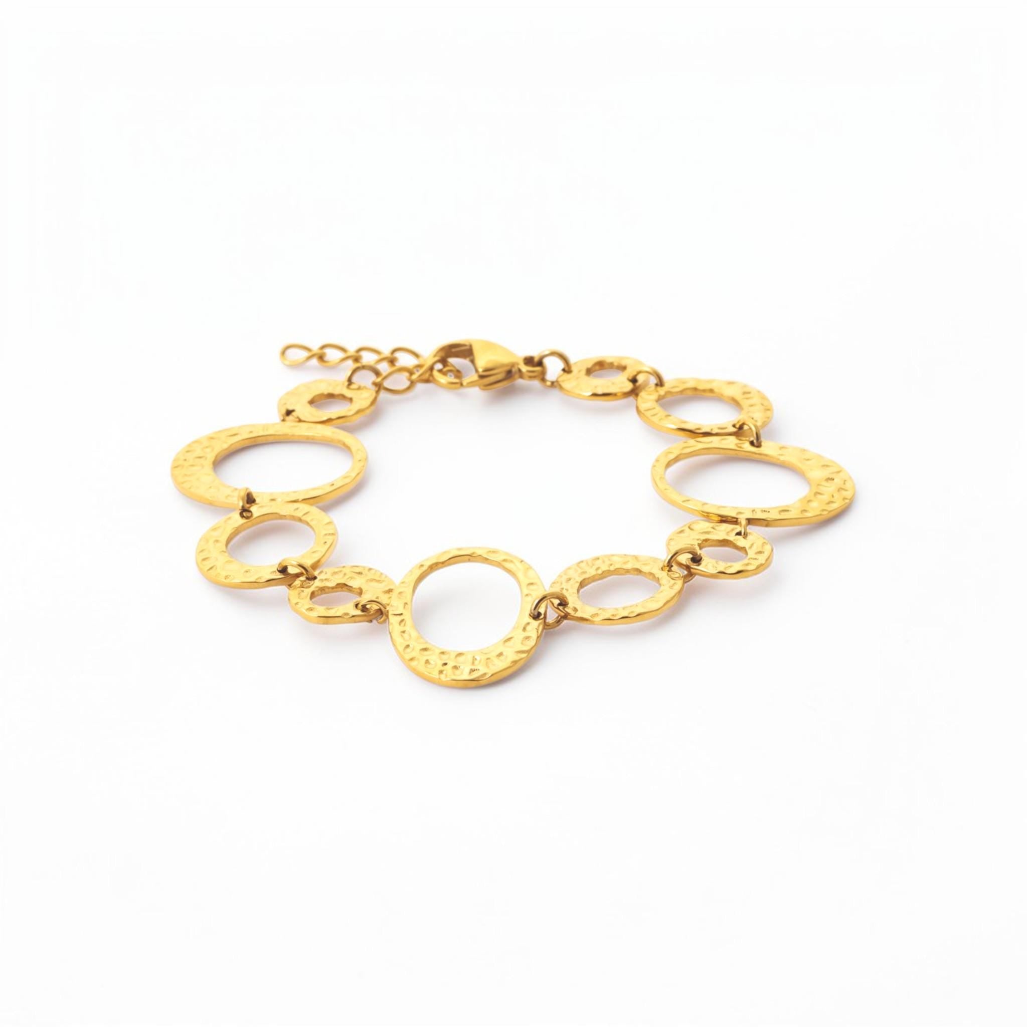 overview of a geometric bracelet closed
Product type: bracelet
Material:  18K Gold Filled, stainless steel base
Color: yellow gold
Style: statement, geometric, elegant, modern
Design details: hammered open circle and oval links, graduated sizes, textured finish, airy openwork design, lobster clasp with extender
Best for: statement styling, special occasions, everyday elevated wear, gifting, artistic jewelry lovers