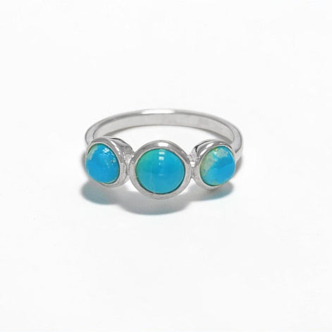 Product type: ring
Material: 925 sterling silver
Stone: turquoise
Color: silver with blue turquoise
Style: elegant, delicate, minimalist, feminine
Design details: slim sterling silver band, three round turquoise stones, polished setting, fine stackable profile, clean balanced design
Best for: everyday wear, stacking, gift giving, women who love turquoise jewelry, delicate gemstone rings, minimalist silver jewelry