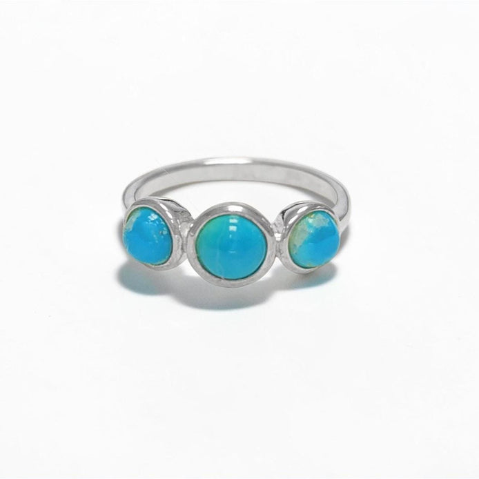 Product type: ring
Material: 925 sterling silver
Stone: turquoise
Color: silver with blue turquoise
Style: elegant, delicate, minimalist, feminine
Design details: slim sterling silver band, three round turquoise stones, polished setting, fine stackable profile, clean balanced design
Best for: everyday wear, stacking, gift giving, women who love turquoise jewelry, delicate gemstone rings, minimalist silver jewelry