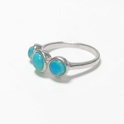 Product type: ring
Material: 925 sterling silver
Stone: turquoise
Color: silver with blue turquoise
Style: elegant, delicate, minimalist, feminine
Design details: slim sterling silver band, three round turquoise stones, polished setting, fine stackable profile, clean balanced design
Best for: everyday wear, stacking, gift giving, women who love turquoise jewelry, delicate gemstone rings, minimalist silver jewelry