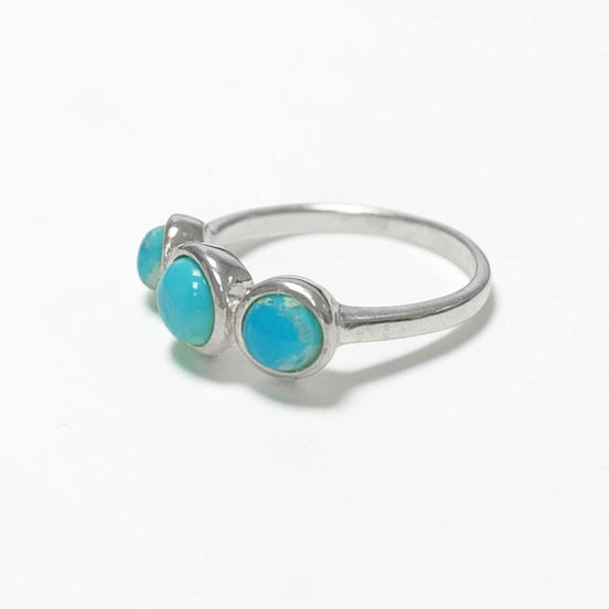 Product type: ring
Material: 925 sterling silver
Stone: turquoise
Color: silver with blue turquoise
Style: elegant, delicate, minimalist, feminine
Design details: slim sterling silver band, three round turquoise stones, polished setting, fine stackable profile, clean balanced design
Best for: everyday wear, stacking, gift giving, women who love turquoise jewelry, delicate gemstone rings, minimalist silver jewelry