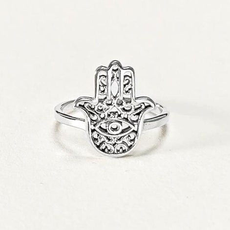 Product type: ring
Material: sterling silver
Color: silver
Style: spiritual, symbolic, boho, delicate
Design details: Hamsa hand motif, centered evil eye symbol, openwork detailing, slim sterling silver band, minimalist everyday silhouette
Best for: everyday wear, symbolic jewelry lovers, spiritual gifting, protection-themed jewelry, stacking, birthdays, anniversaries, Mother’s Day