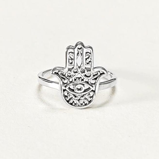Product type: ring
Material: sterling silver
Color: silver
Style: spiritual, symbolic, boho, delicate
Design details: Hamsa hand motif, centered evil eye symbol, openwork detailing, slim sterling silver band, minimalist everyday silhouette
Best for: everyday wear, symbolic jewelry lovers, spiritual gifting, protection-themed jewelry, stacking, birthdays, anniversaries, Mother’s Day