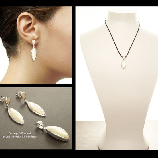 Un ensemble de boucles d'oreilles et d'un pendentif en argent avec un motif ovale en nacre blanche. Les boucles d'oreilles sont des boucles d'oreilles pendantes avec le pendentif assorti, faits main par des créateurs passionnés. KRAMIKE est une boutique validée par des milliers de ventes.